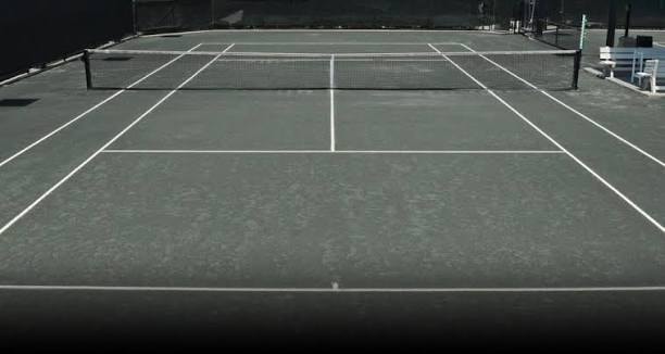 Har-Tru green clay court surface texture — stays cooler than asphalt in summer heat